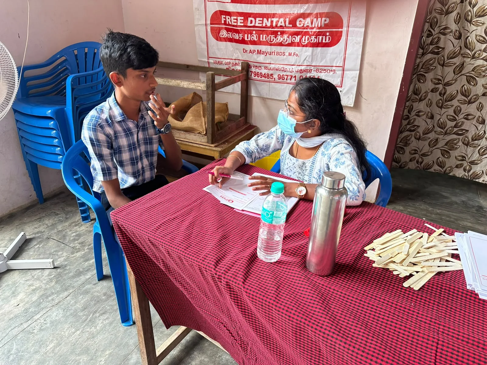 Dr. Mayuri AP conducting consultation at free dental camp table
