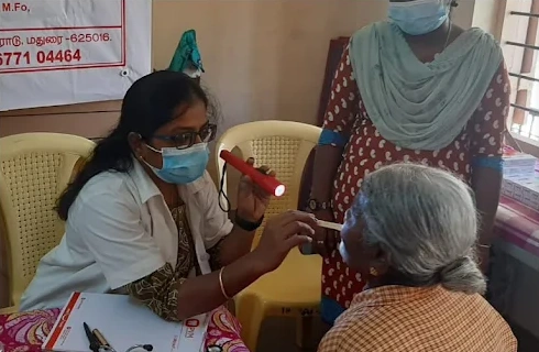 Dr. Mayuri AP conducting oral health checkup at PVM Free Dental Camp in Madurai